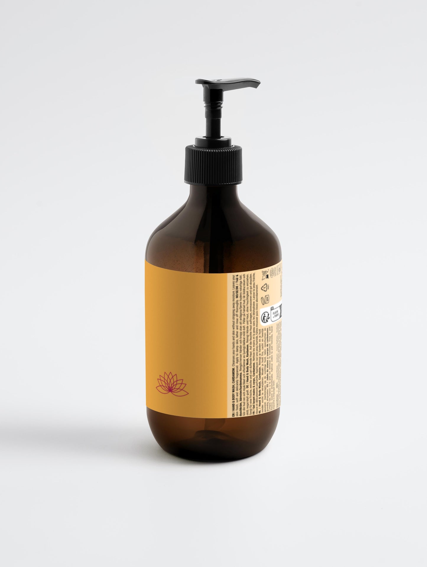 Amber glass bottle with pump and yellow label on a white background