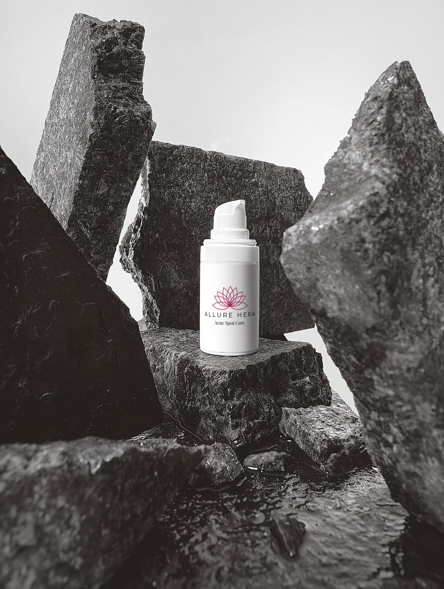Skincare bottle with a brand logo on a stone surface