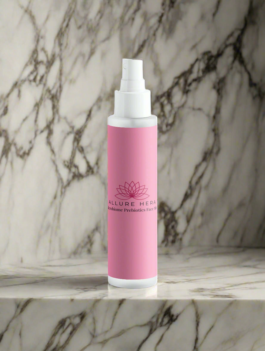 Pink spray bottle with white cap on a light gray background