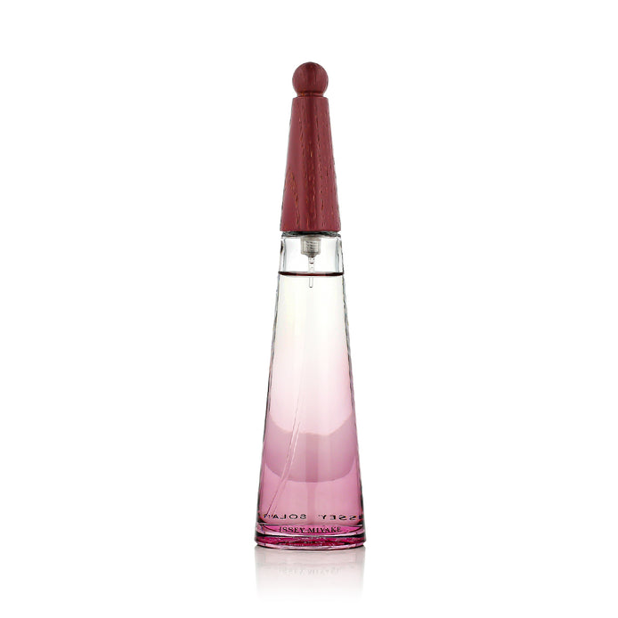 Perfume bottle with pink gradient design on a white background