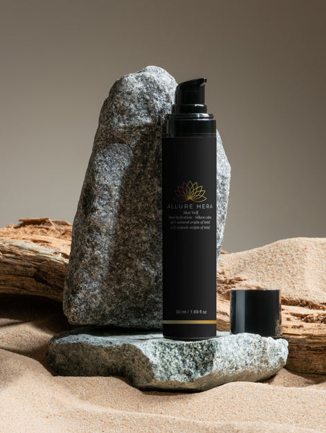 Black skincare product with brand logo on a rock and wooden background