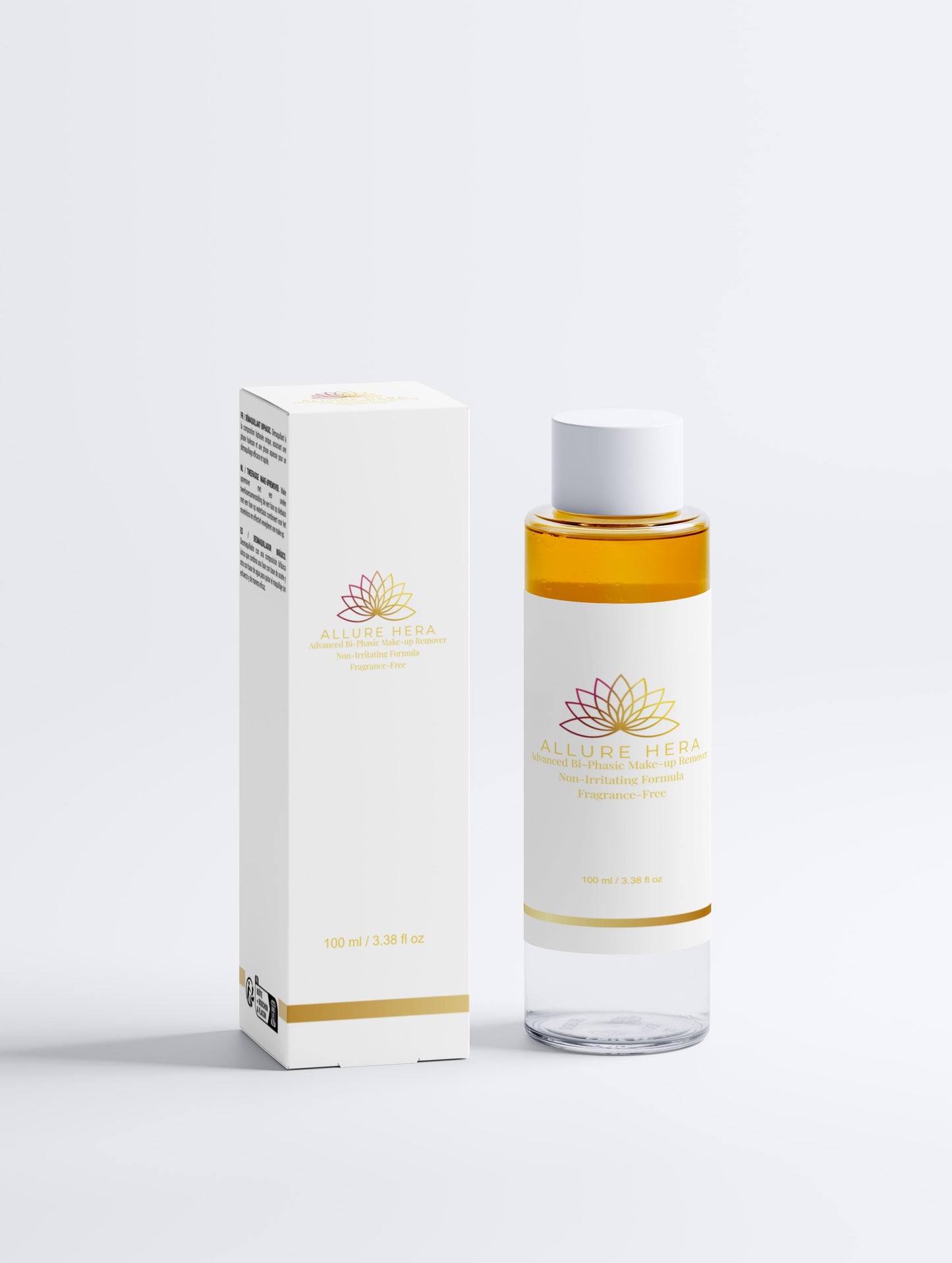 Clear bottle with gold cap and white label next to a white box with gold accents on a light gray background
