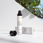 Pure Hyaluronic Cream in a sleek container, with a white box, displayed among green leaves for an organic aesthetic.