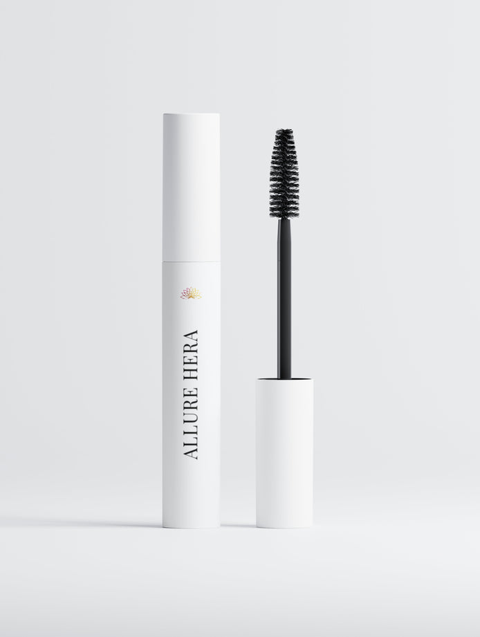 Mascara with white cylindrical container and black brush on a light gray background