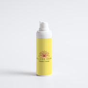 Yellow serum bottle with white cap on a light gray background