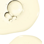 Close-up of rosemary hair and scalp strengthening oil with bubbles on a white background.