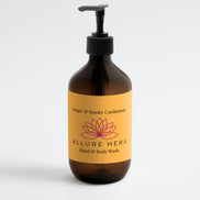 Brown bottle of Allure Hera hand and body wash with a yellow label on a white background